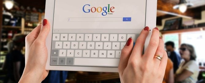 Women holding ipad with google on screen